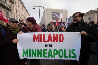 Protesters in Milan march with a sign that reads, ‘Milano with Minneapolis’
